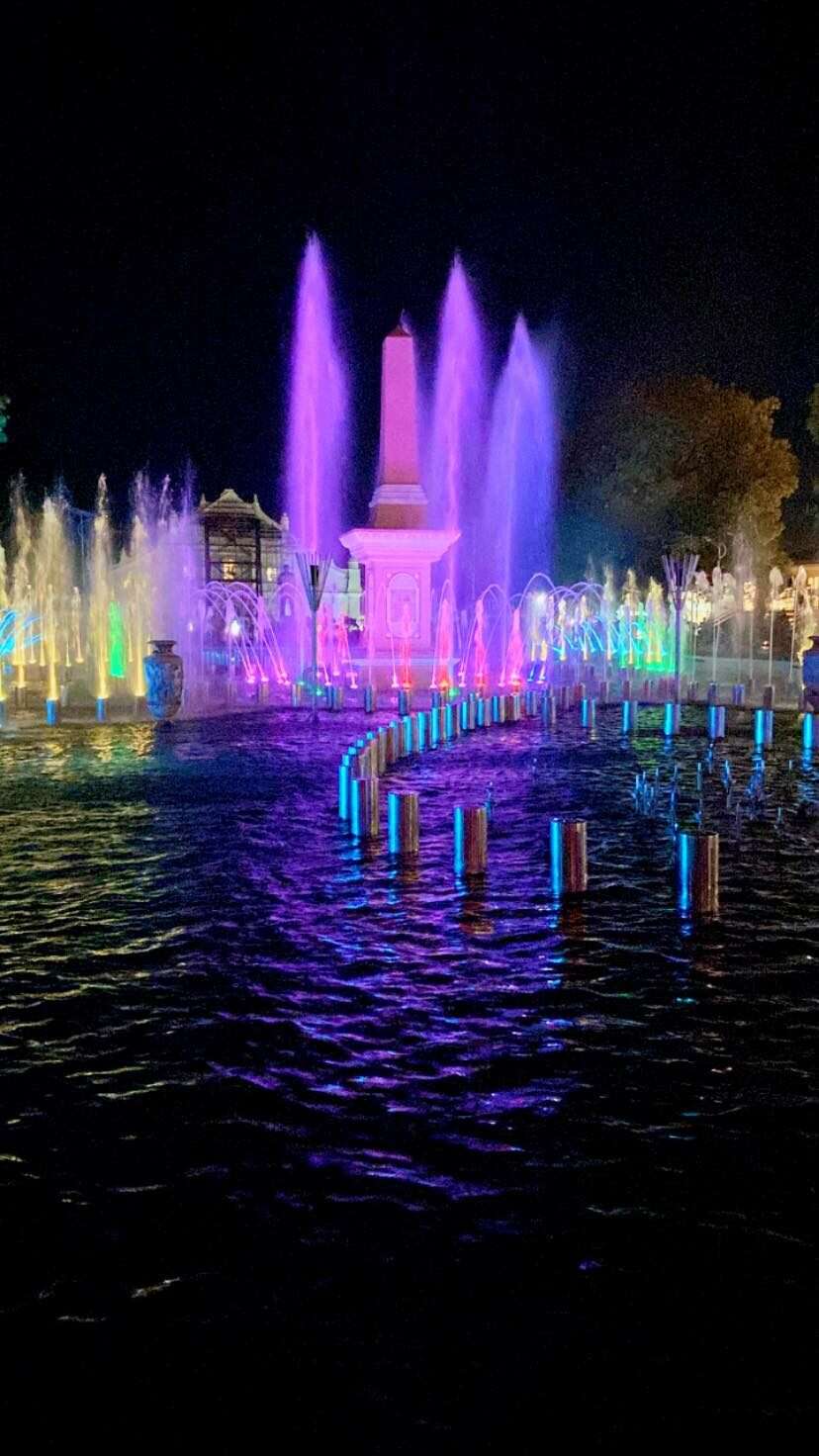 Plaza Salcedo Vigan dancing fountain show at night with colorful purple and blue illuminated water jets