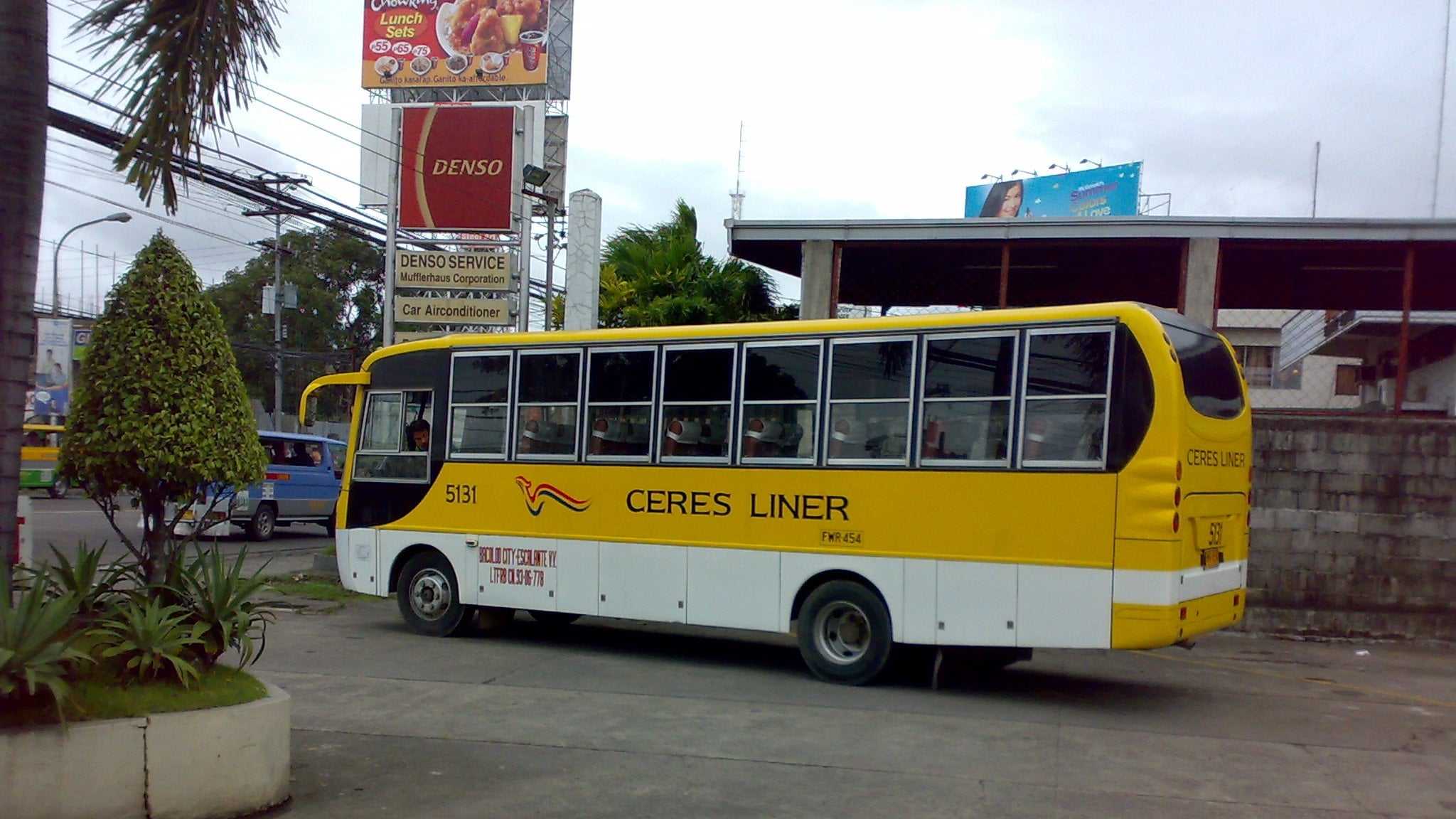 A yellow Ceres Liner bus parked at a terminal, the kind that runs from Cebu South Bus Terminal to Moalboal