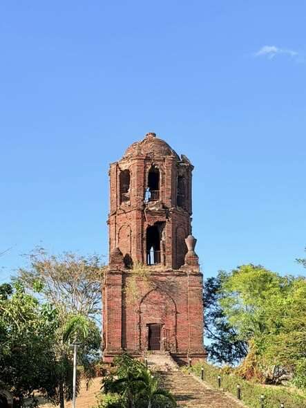 Bantay Bell Tower Vigan ancient red-brick Spanish colonial bell tower against clear blue sky