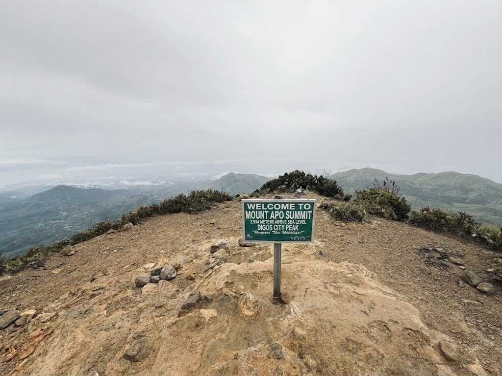 Mount Apo summit sign at 2,954 meters above sea level with panoramic mountain views in Davao Philippines