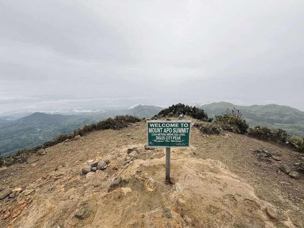 Mount Apo summit sign at 2,954 meters above sea level with panoramic mountain views in Davao Philippines