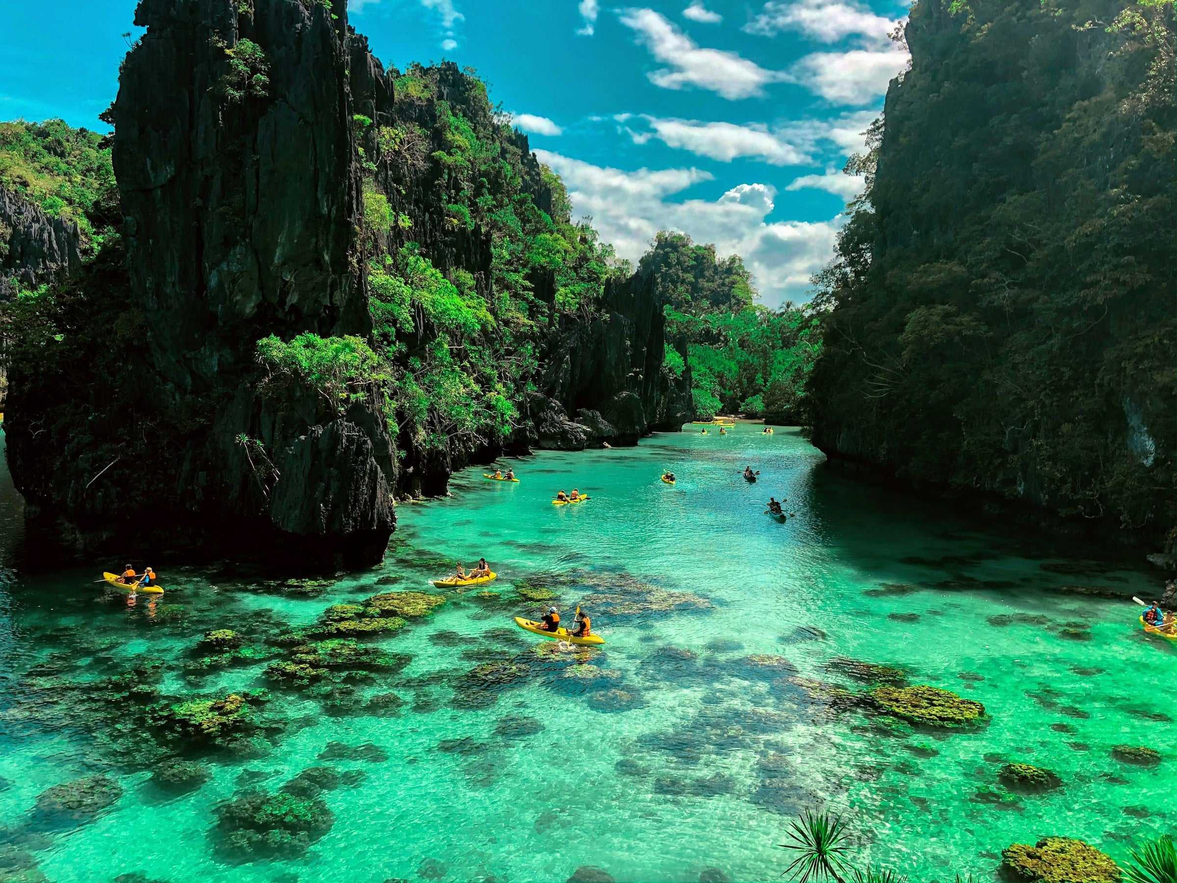 El Nido Big Lagoon clear turquoise water between towering limestone karst cliffs in Palawan Philippines
