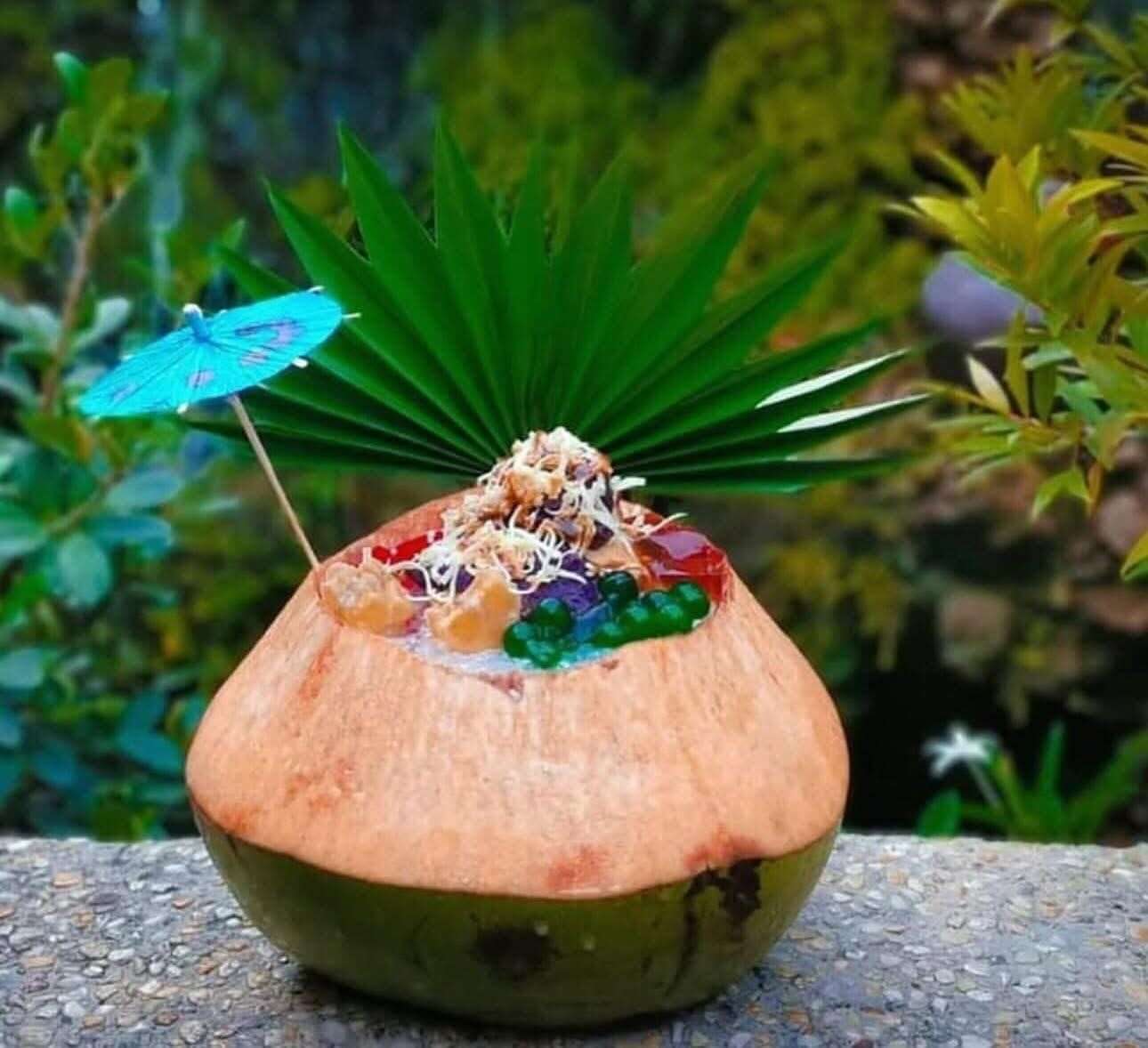 Halo-Halo de Iloko famous La Union dessert served in a coconut shell with colorful jelly and ube ice cream