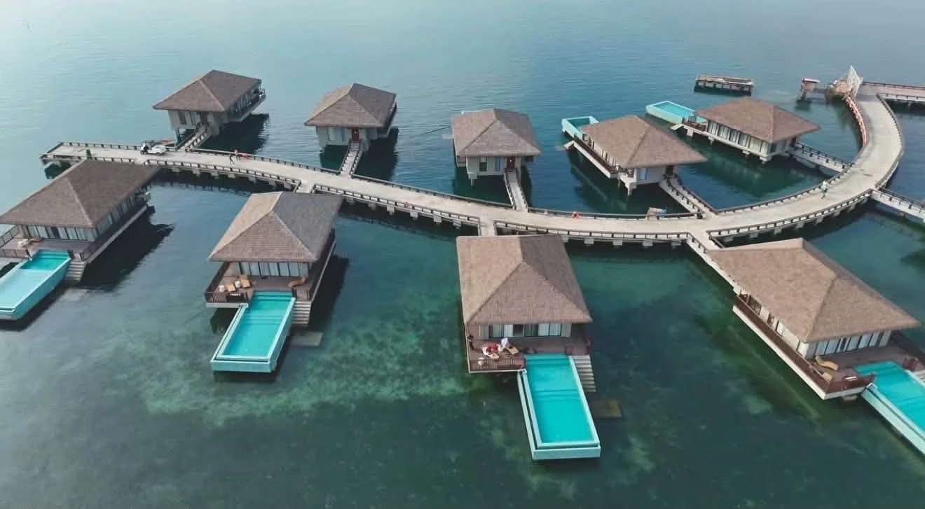 Aerial view of AMORAP's Ocean Villas by the Sea on a boardwalk over turquoise water in Sinacaban, Misamis Occidental