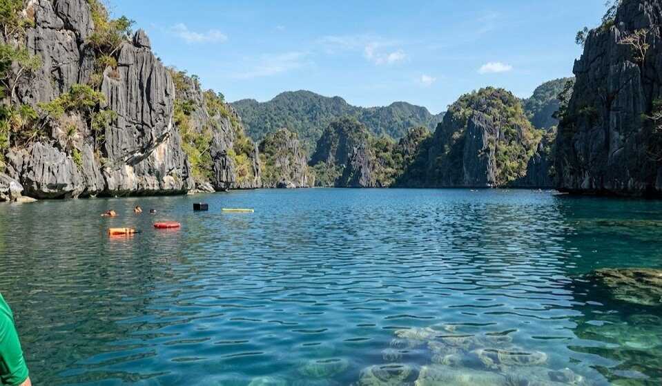 Barracuda Lake Coron clear blue water surrounded by dramatic vertical limestone karst formations