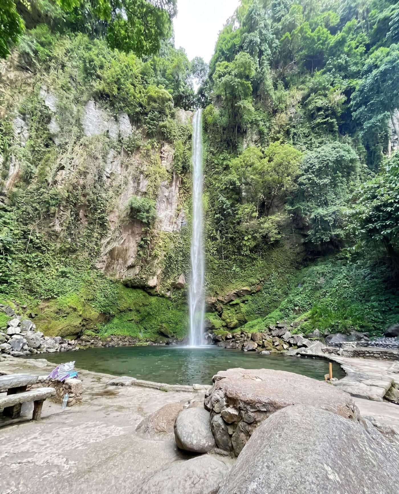 Katibawasan Falls Camiguin 76-meter waterfall cascading down lush jungle cliff into natural pool
